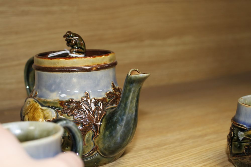 A Royal Doulton fish and pond weed three-piece tea set, designed by George Tinworth, made c.1905, teapot 13cm high